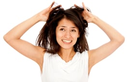 Desperate woman having a bad hair day - isolated over a white background